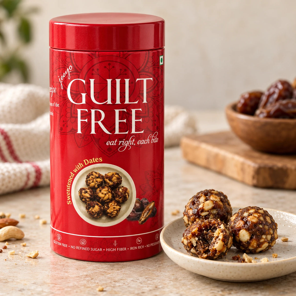 Guilt Free Date Bites tin beside whole and broken date-and-nut bites on a plate.